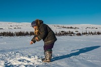Ice fishing with Inuit woman around Kangiqsualujjuaq, Canada