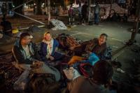 Late evening, in a parking lot  Afghani refugees in a parking lot where they will spend the night in Belgrade, Serbia.