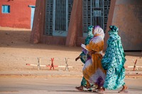 Women strolling in a desert village
