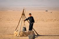 A Syrian boy fetching water in a well during a climate induced drought in The Northeast Syria.