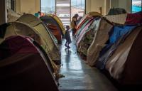many 100s of refugees camping in the old Athens airport in the old departure terminal in Greece