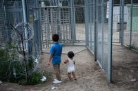 Afghani refugee children in the make-shift camp are looking at the fence of the closed border crossing between the Hungarian and Serbian border in  Horgos Serbia. 
