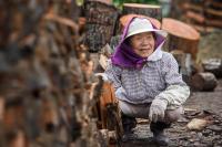 Woman working with logs of wood in northern Hokkaido, Japan