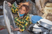 Bedouin girl doing the dishes