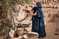Tuareq woman carving a goat skin