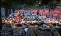 an early morning, Iraqi, Afghani, Syrian and Iranian refugees  are waking up on a square  in Belgrade, Serbia.