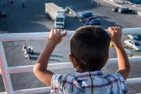 Kurdish Syrian refugee child is leaving Lesbos on the ferry to Athens.