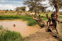 Refugees from Congo swim in a little water hole close to the Nakivale refugee settlement in Isingiro district, South West
Uganda.  Dorte Verner/World Bank