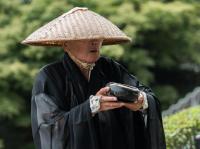 A Buddhist monk begging for alms in Kyoto, Japan