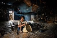 Naga Man Making Baskets Next to the Fire, Myanmar